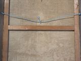 an old picture of a wooden frame with a rope hanging from it