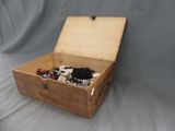 a wooden box filled with assorted items on a gray background