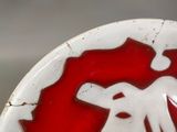 a red and white plate with a picture of an elephant on it