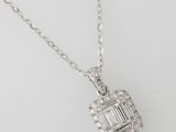 a white gold and diamond pendant with a baguet