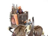 a figurine of an elephant pulling a cart with people on it