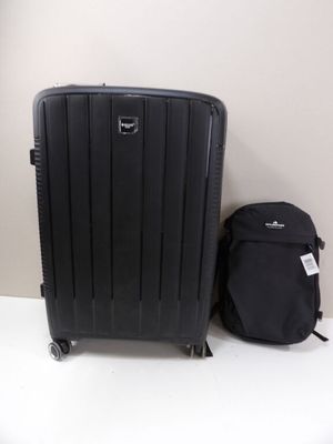 a piece of luggage sitting next to a backpack on the floor