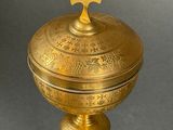 a golden box with a cross on top of it