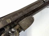 a close up of a gun on a white surface