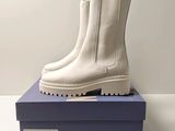 the white boots are sitting on top of a blue box
