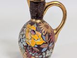 a small vase with a floral design on it