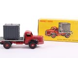 a red toy truck with a box on the back of it