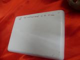 a white plate with writing on it sitting on a table