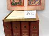 four books are stacked on top of each other on a white surface