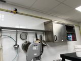 a kitchen with a lot of pots and pans hanging on the wall