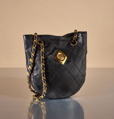 black quilted purse with gold hardware and chain strap
