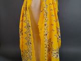 an image of a yellow scarf on a mannequin head