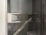 a stainless steel cabinet with two trays inside of it