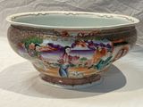 a large bowl with a painting on it sitting on a table