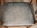 a wooden chair with a blue cushion on top of it