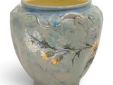 a blue vase with yellow flowers on it on a white background