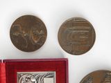 several coins and a picture of a man on a horse in a red box