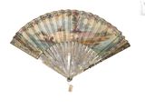a fan with a painting on it hanging on a wall