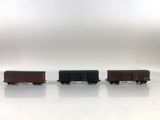 three toy trains are lined up in a row on a white surface