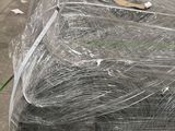 many rolls of wire wrapped in plastic on the ground