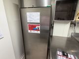 a stainless steel refrigerator in a kitchen with a lot of counter space