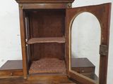 a small wooden table with a mirror on top of it