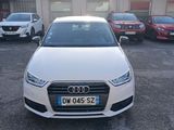 the white audi car is parked in a parking lot with other cars