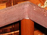 a close up view of a corner of a bed with a wooden headboard