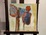 a painting of a man holding a mirror on a easel