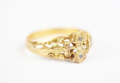 a close up of a gold ring on a white surface