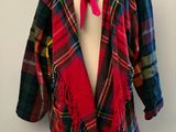 a red scarf on a mannequin with a red bow