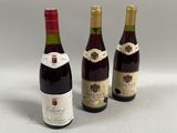 trois bouteilles de vin posées l'une à côté de l'autre sur une table