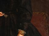 portrait of a woman in a black dress with a gold chain around her neck
