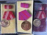 three medals and a medal in a display case on a table
