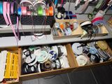 a desk with a drawer full of sewing supplies