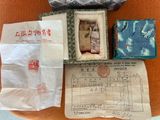 a small box with a doll inside of it on a chair