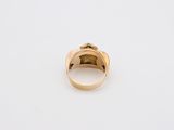 a gold ring on a white surface