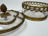 two glass dishes with gold trimmings on them
