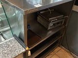 a counter that has a glass case on top of it