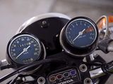 two gauges on the handlebars of a motorcycle