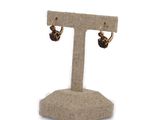 pair of earrings on a stand on a white background