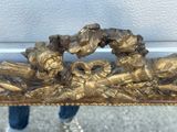 a gold sculpture of a group of birds sitting on a bench