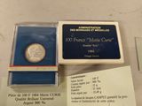 a silver coin and a blue box on a table