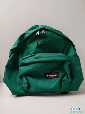 a close up of a green backpack sitting on a white surface