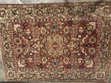a large antique persian rug with a red and blue design