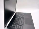 a laptop that is open on a white surface