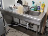 a kitchen with a sink and a refrigerator in it
