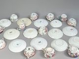 many different types of teapots and saucers on the table