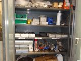 a tall metal cabinet with many items on it