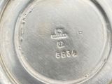 an image of a close up of a silver plate with a number on it